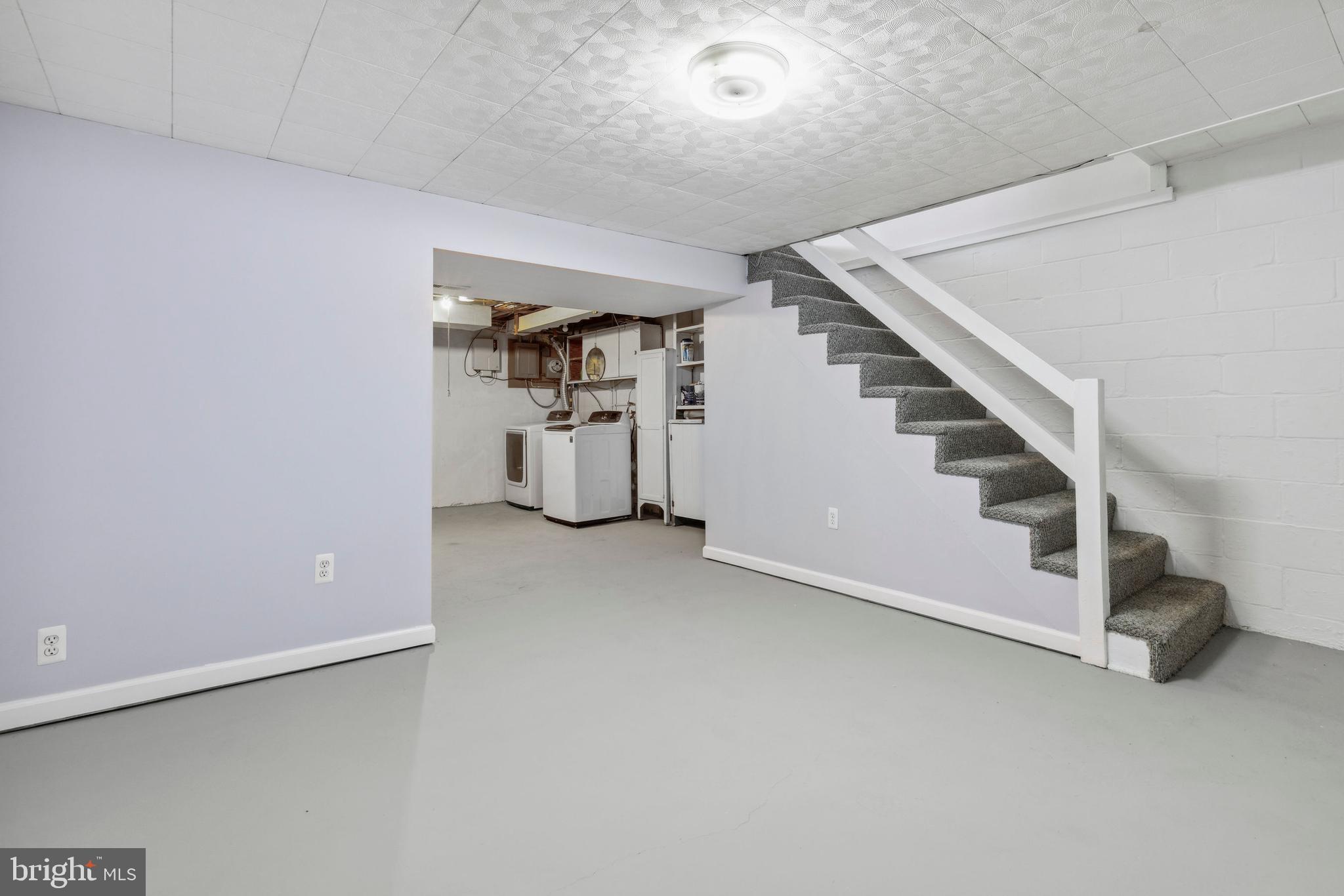 3418 Dunran Road Baltimore, MD 21222 - Photo 14 of 19 a view of a livingroom with stairs and white walls