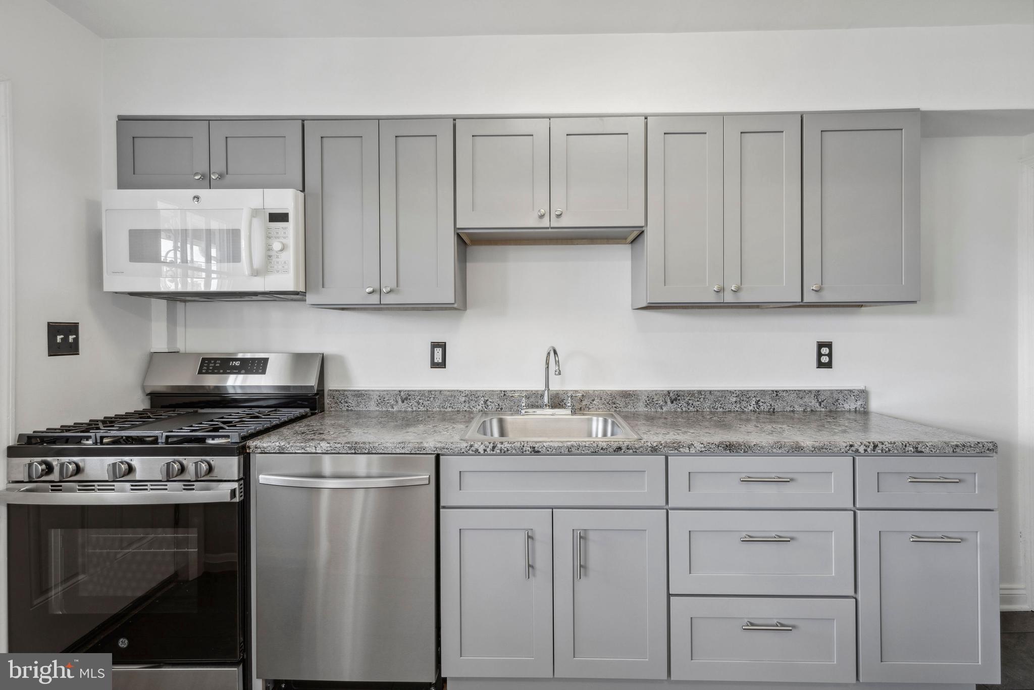3418 Dunran Road Baltimore, MD 21222 - Photo 5 of 19 a kitchen with granite countertop white cabinets and stainless steel appliances