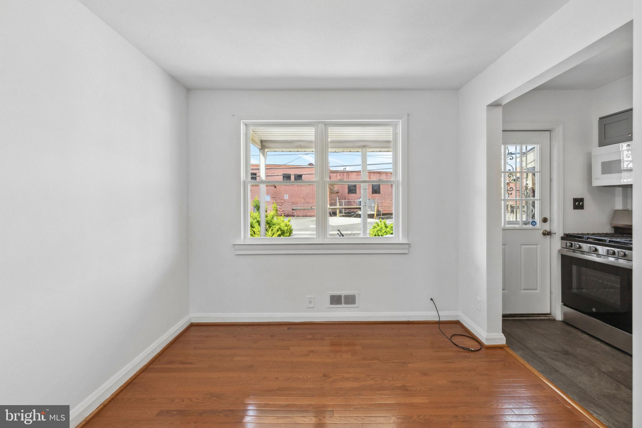 3418 Dunran Road Baltimore, MD 21222 - Photo 6 of 19 a view of a kitchen with wooden floor and electronic appliances
