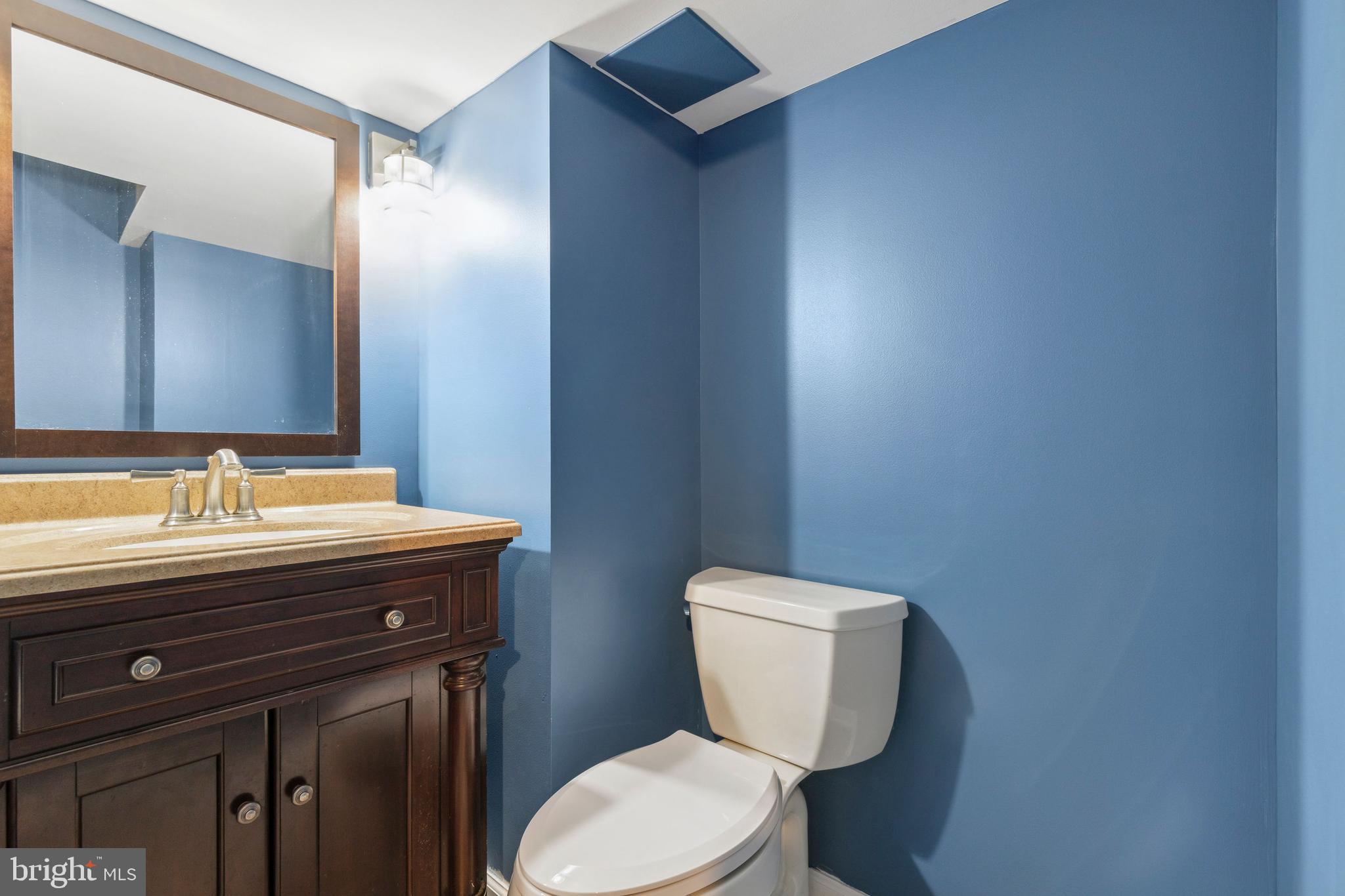 3418 Dunran Road Baltimore, MD 21222 - Photo 7 of 19 a bathroom with a granite countertop toilet sink and mirror