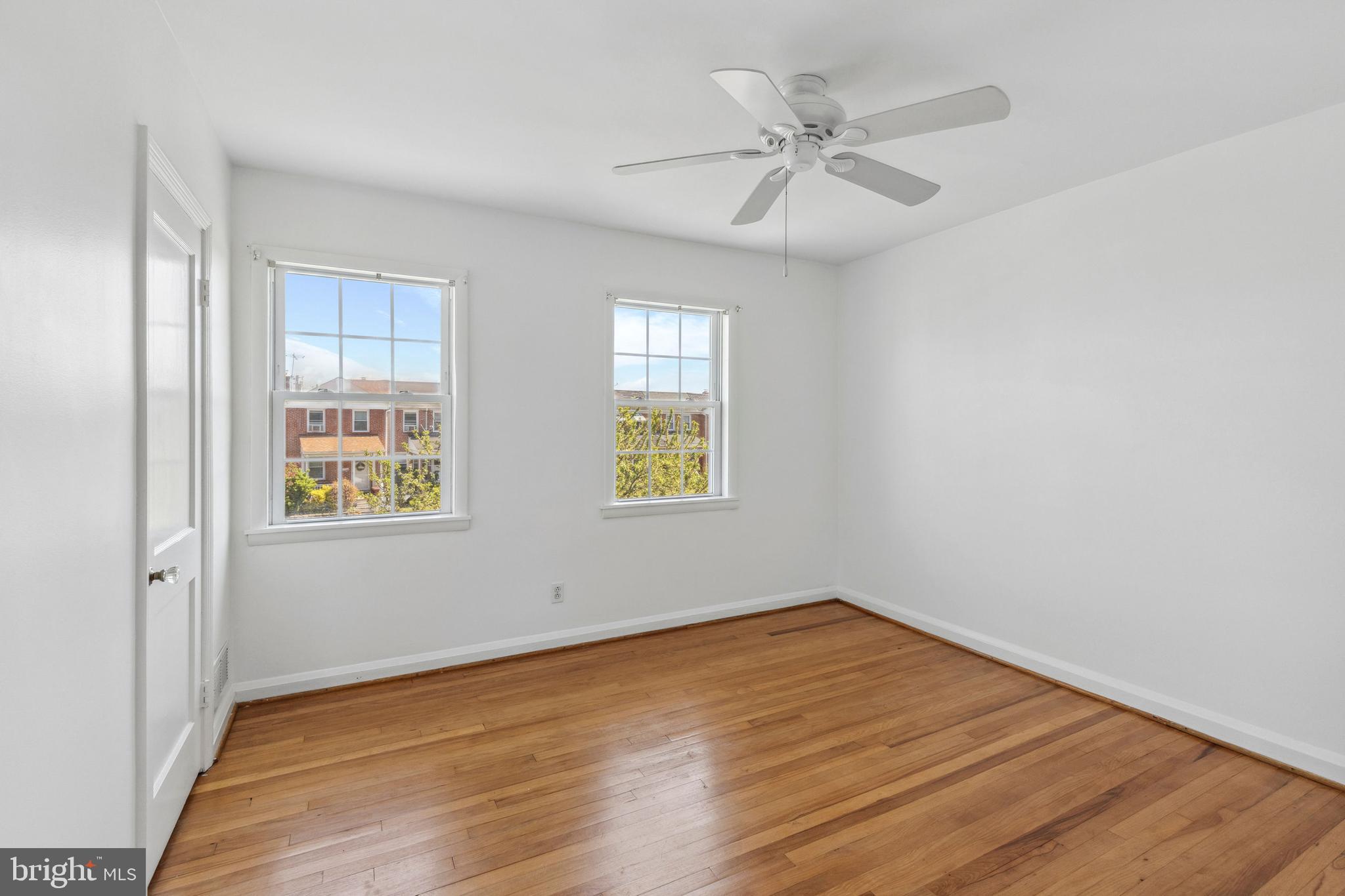 3418 Dunran Road Baltimore, MD 21222 - Photo 10 of 19 wooden floor in an empty room with a window