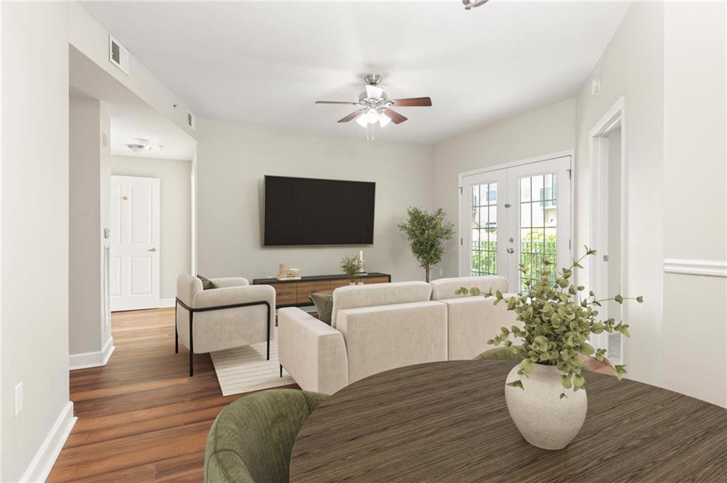 230 East Ponce De Leon Avenue, Unit 104 Decatur, GA 30030 - Photo 13 of 27 a living room with furniture a chandelier and a flat screen tv