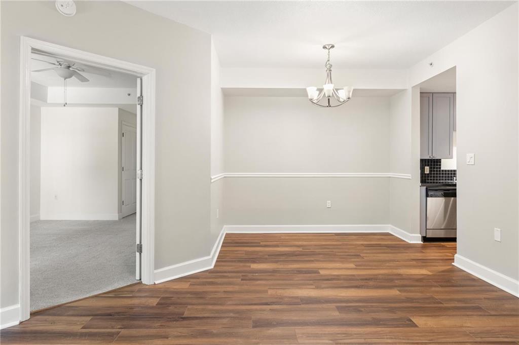 230 East Ponce De Leon Avenue, Unit 104 Decatur, GA 30030 - Photo 14 of 27 a view of empty room with wooden floor and windows