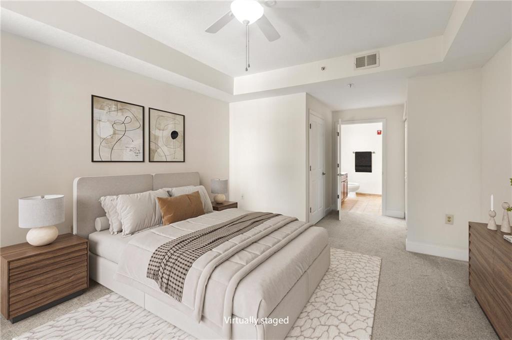 230 East Ponce De Leon Avenue, Unit 104 Decatur, GA 30030 - Photo 19 of 27 a bedroom with a bed and a chandelier