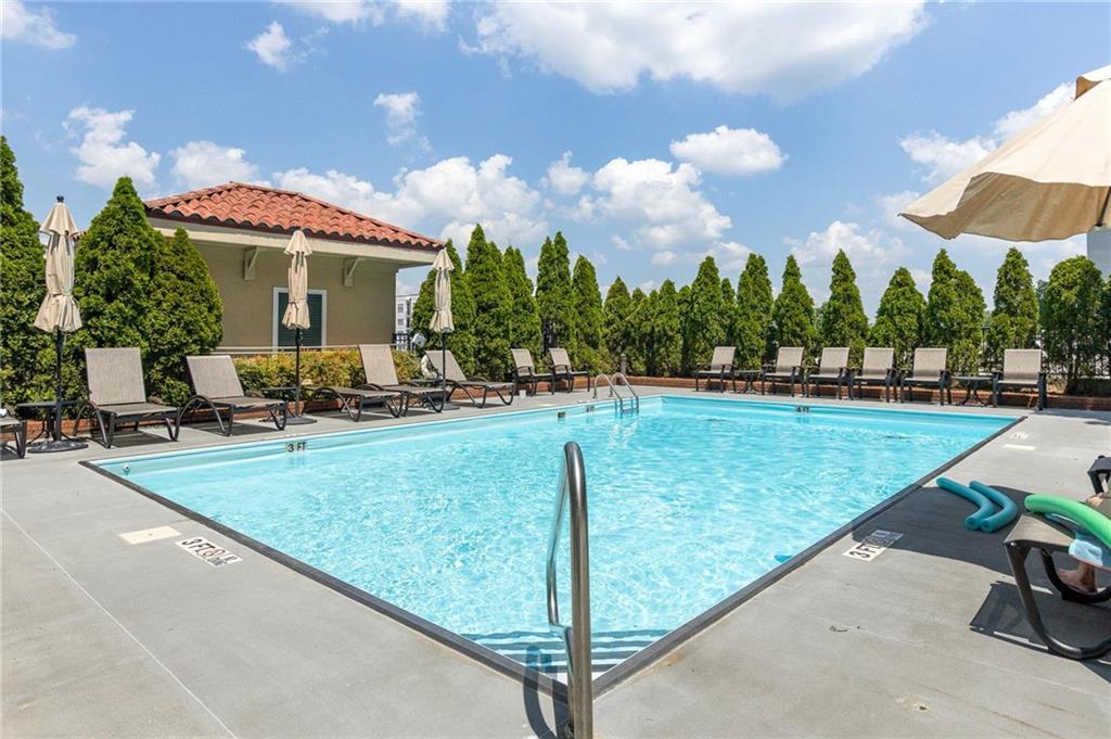 230 East Ponce De Leon Avenue, Unit 104 Decatur, GA 30030 - Photo 2 of 27 a swimming pool with outdoor seating and yard