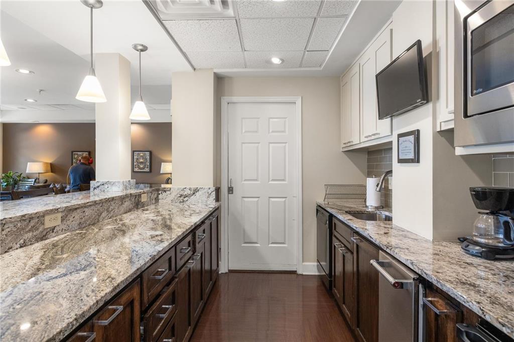 230 East Ponce De Leon Avenue, Unit 104 Decatur, GA 30030 - Photo 4 of 27 a kitchen with granite countertop a sink and a stove