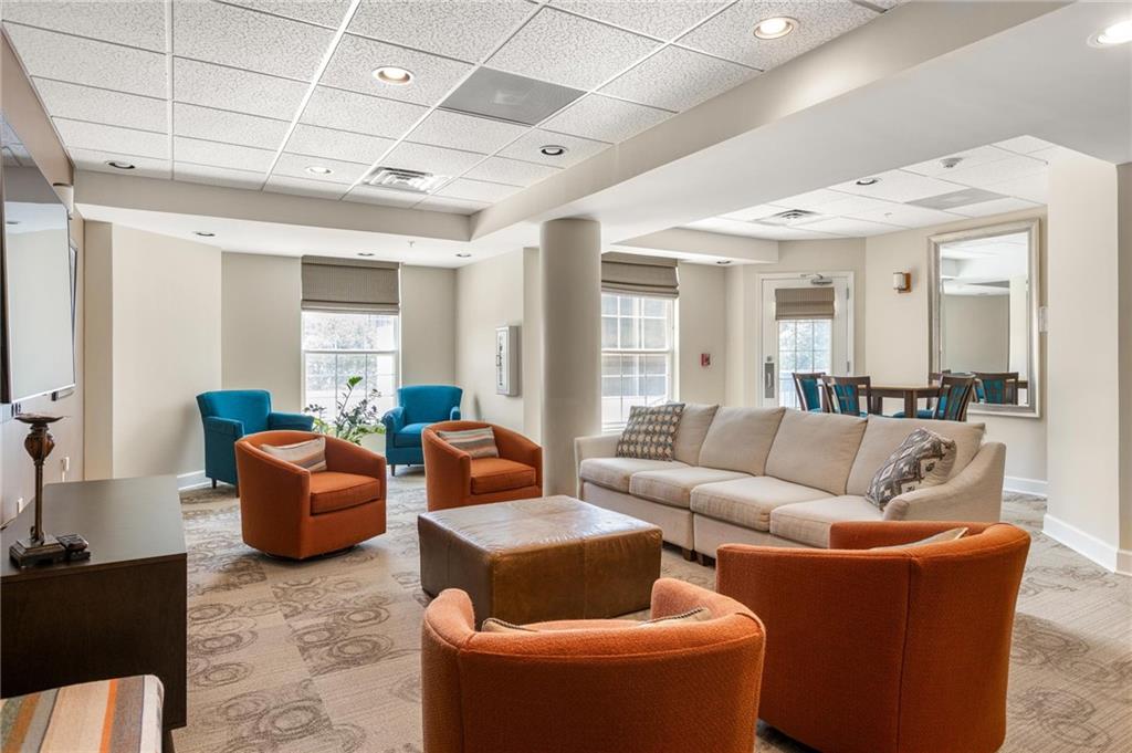 230 East Ponce De Leon Avenue, Unit 104 Decatur, GA 30030 - Photo 6 of 27 a living room with furniture and a large window