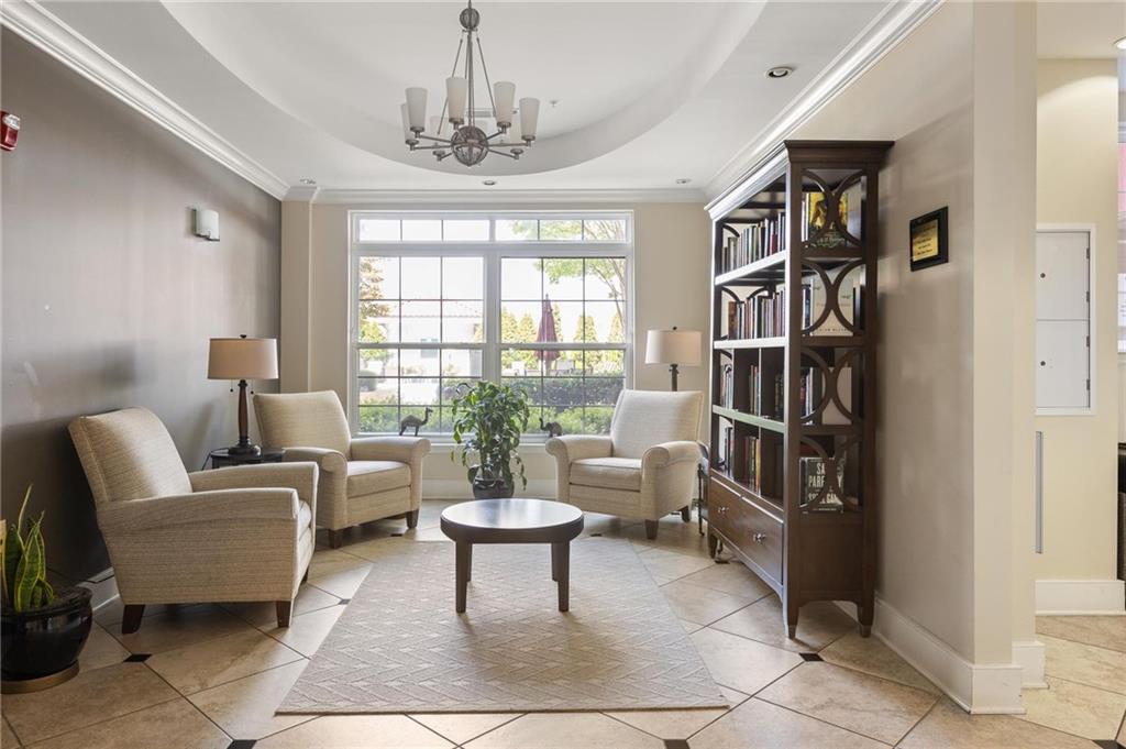 230 East Ponce De Leon Avenue, Unit 104 Decatur, GA 30030 - Photo 8 of 27 a living room with furniture and a chandelier
