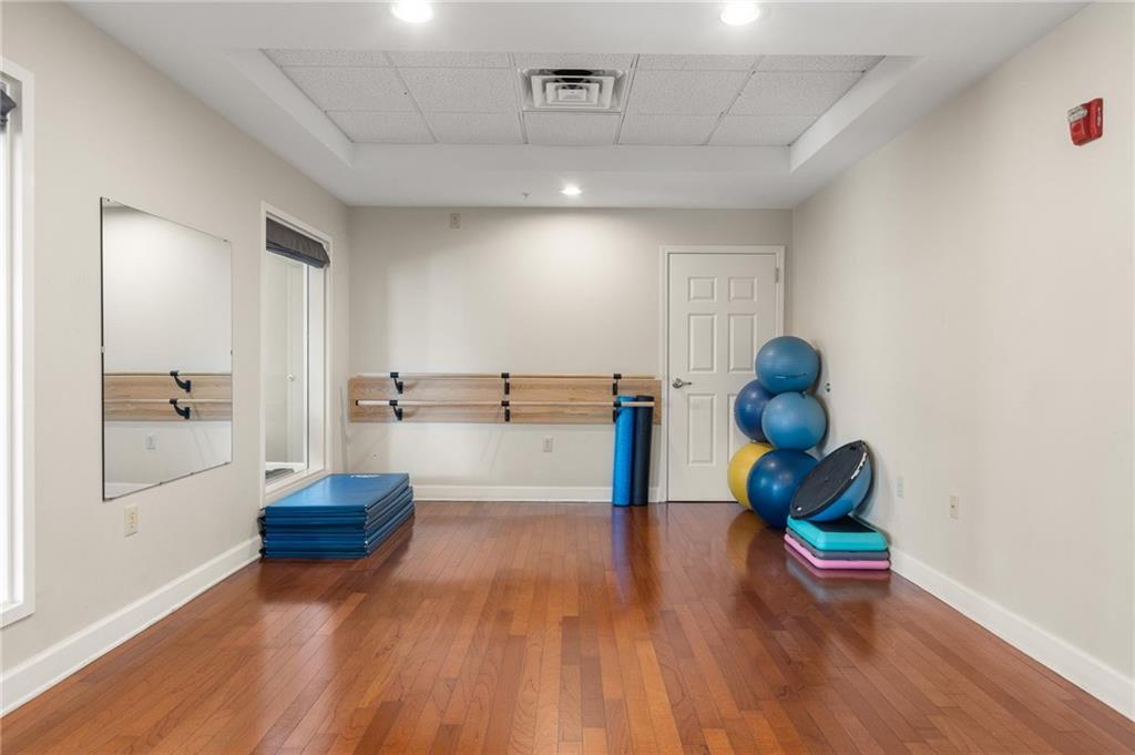 230 East Ponce De Leon Avenue, Unit 104 Decatur, GA 30030 - Photo 9 of 27 a living room with furniture and a potted plant