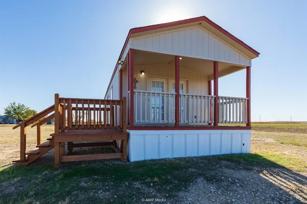 a view of a wooden deck with a backyard