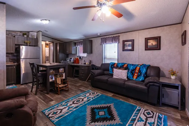 a living room with furniture a chandelier and a dining table