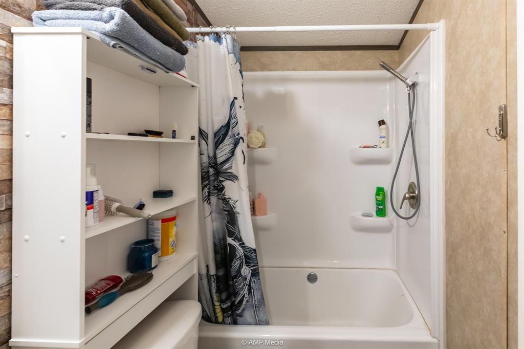 159 Adams Rule, TX 79548 - Photo 8 of 13 a bathroom with a bathtub and shower