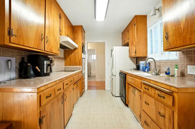 a kitchen with stainless steel appliances a sink and cabinets
