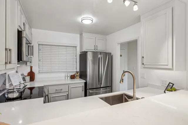 a spacious bedroom with a bed and a large window