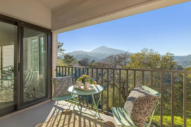 a kitchen with sink a microwave and cabinets