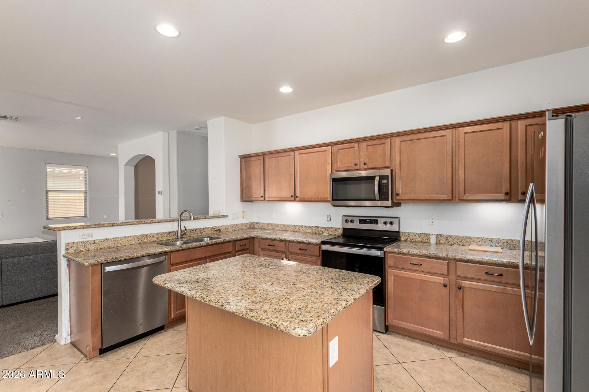 15339 West Jackson Street Goodyear, AZ 85338 - Photo 12 of 36 a kitchen with stainless steel appliances granite countertop a sink stove oven and refrigerator