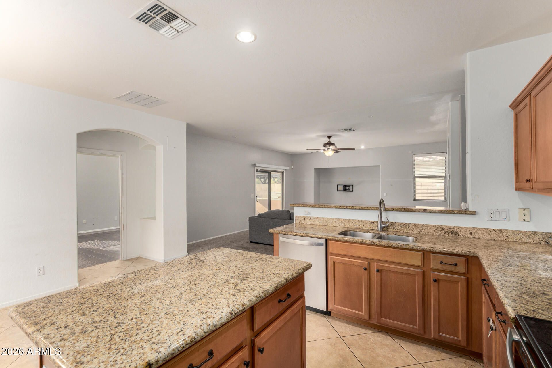 15339 West Jackson Street Goodyear, AZ 85338 - Photo 13 of 36 a spacious bathroom with a granite countertop sink and a mirror