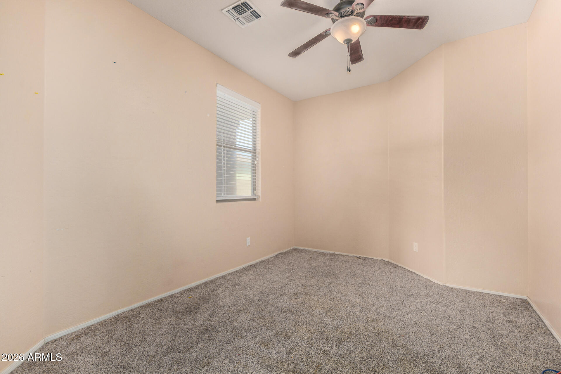 15339 West Jackson Street Goodyear, AZ 85338 - Photo 16 of 36 an empty room with a chandelier fan and windows