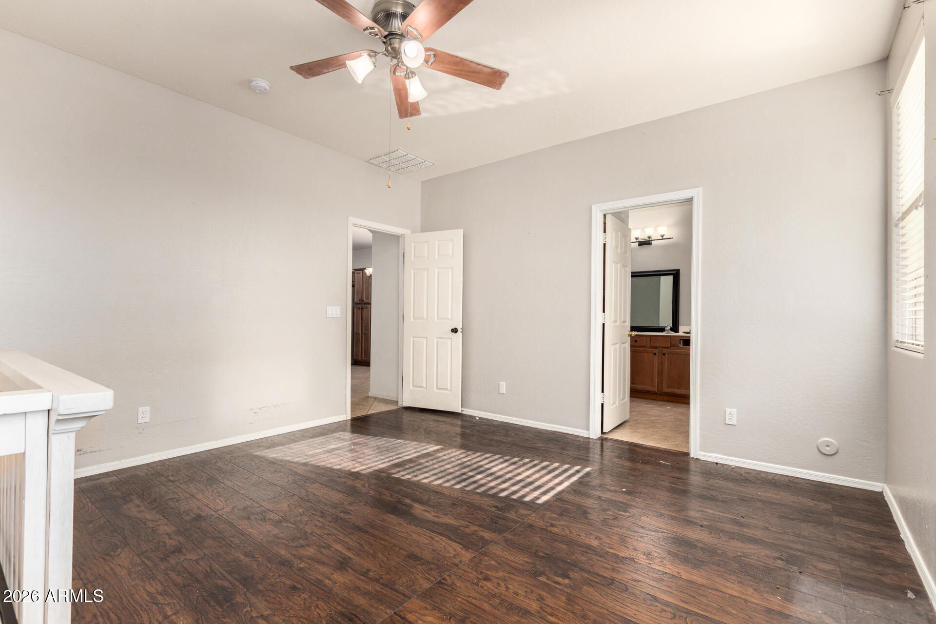 15339 West Jackson Street Goodyear, AZ 85338 - Photo 18 of 36 a view of an empty room with wooden floor