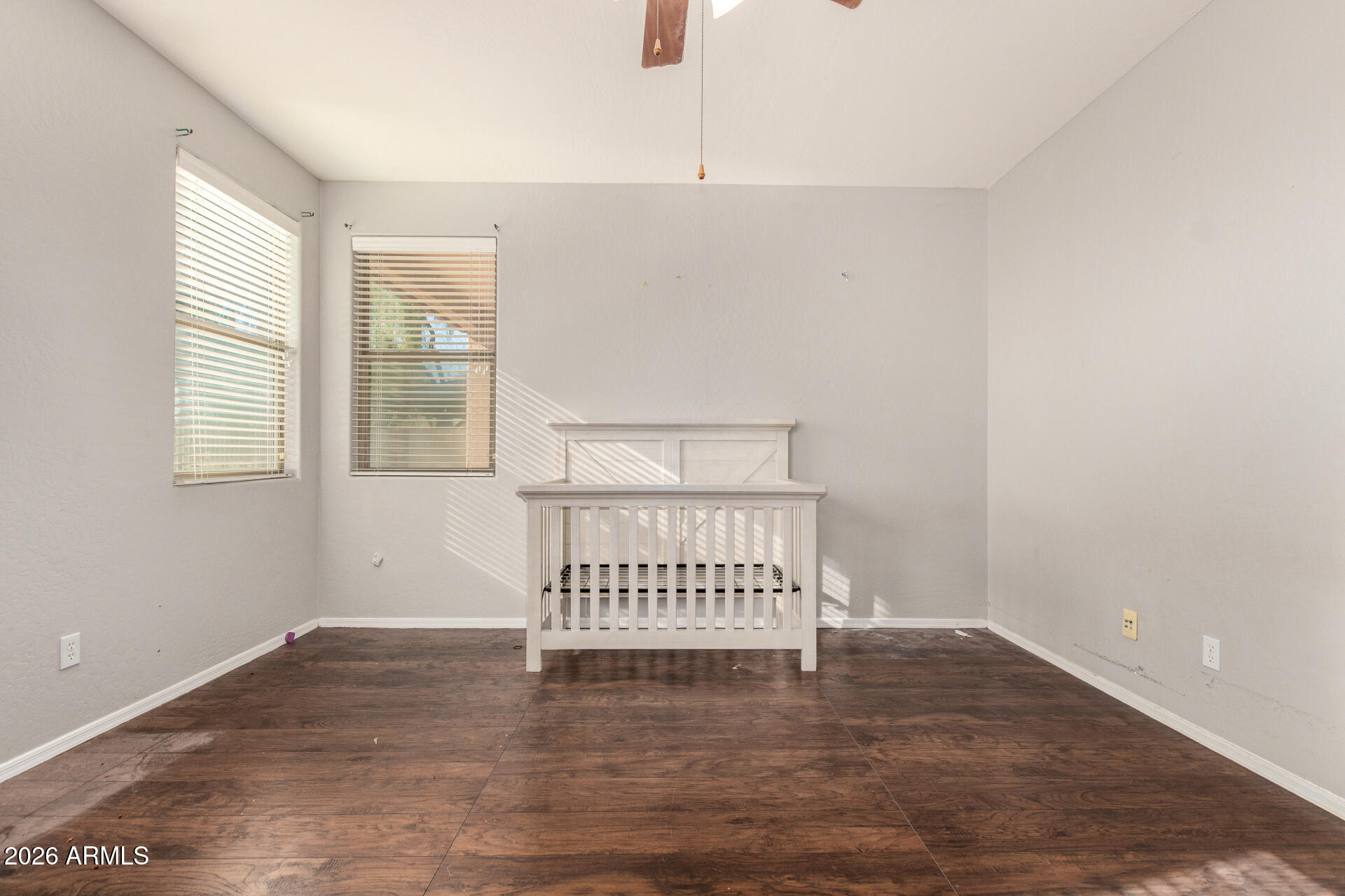 15339 West Jackson Street Goodyear, AZ 85338 - Photo 19 of 36 a view of a room with wooden floor and windows
