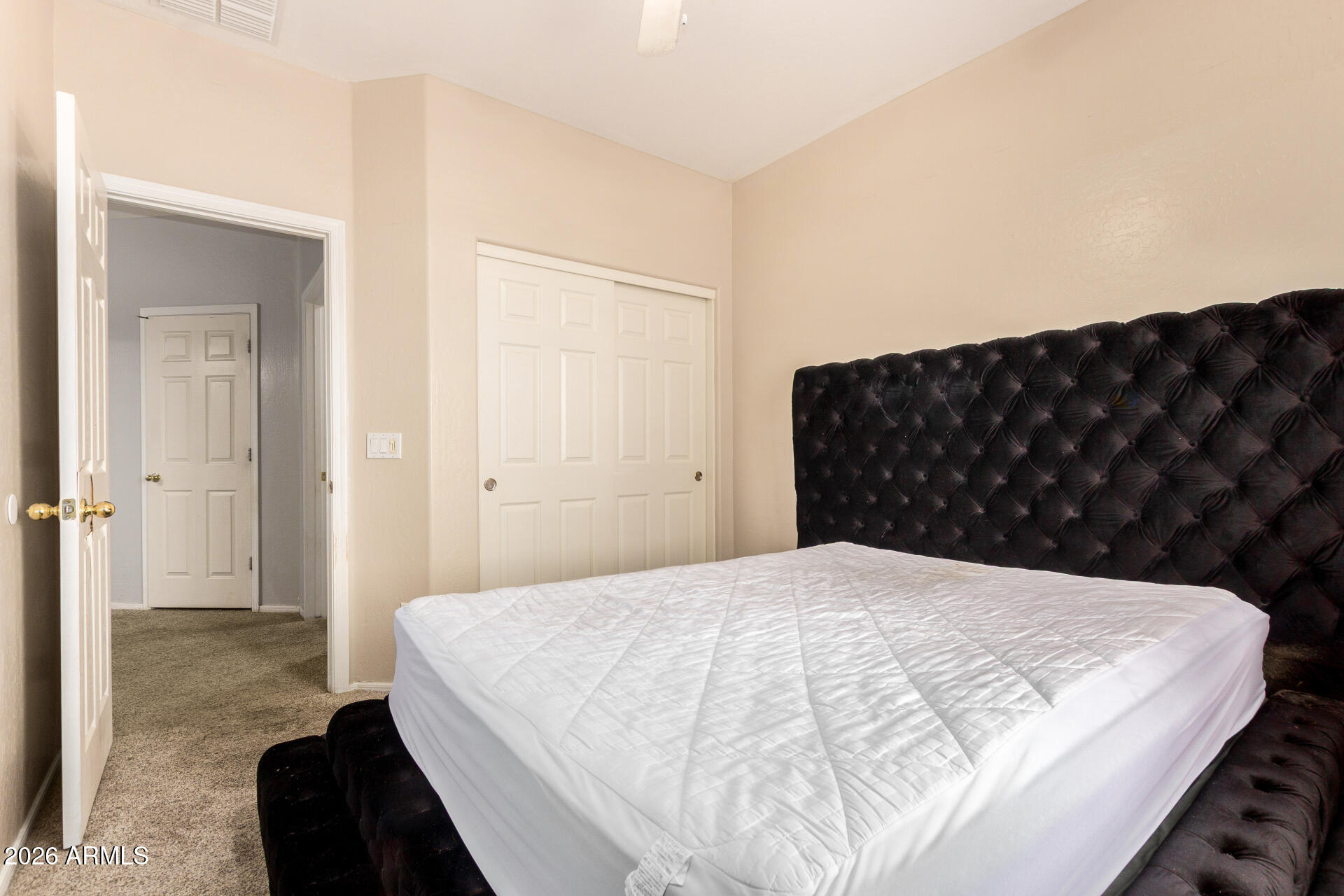 15339 West Jackson Street Goodyear, AZ 85338 - Photo 24 of 36 a bedroom with a bed and a walk in closet