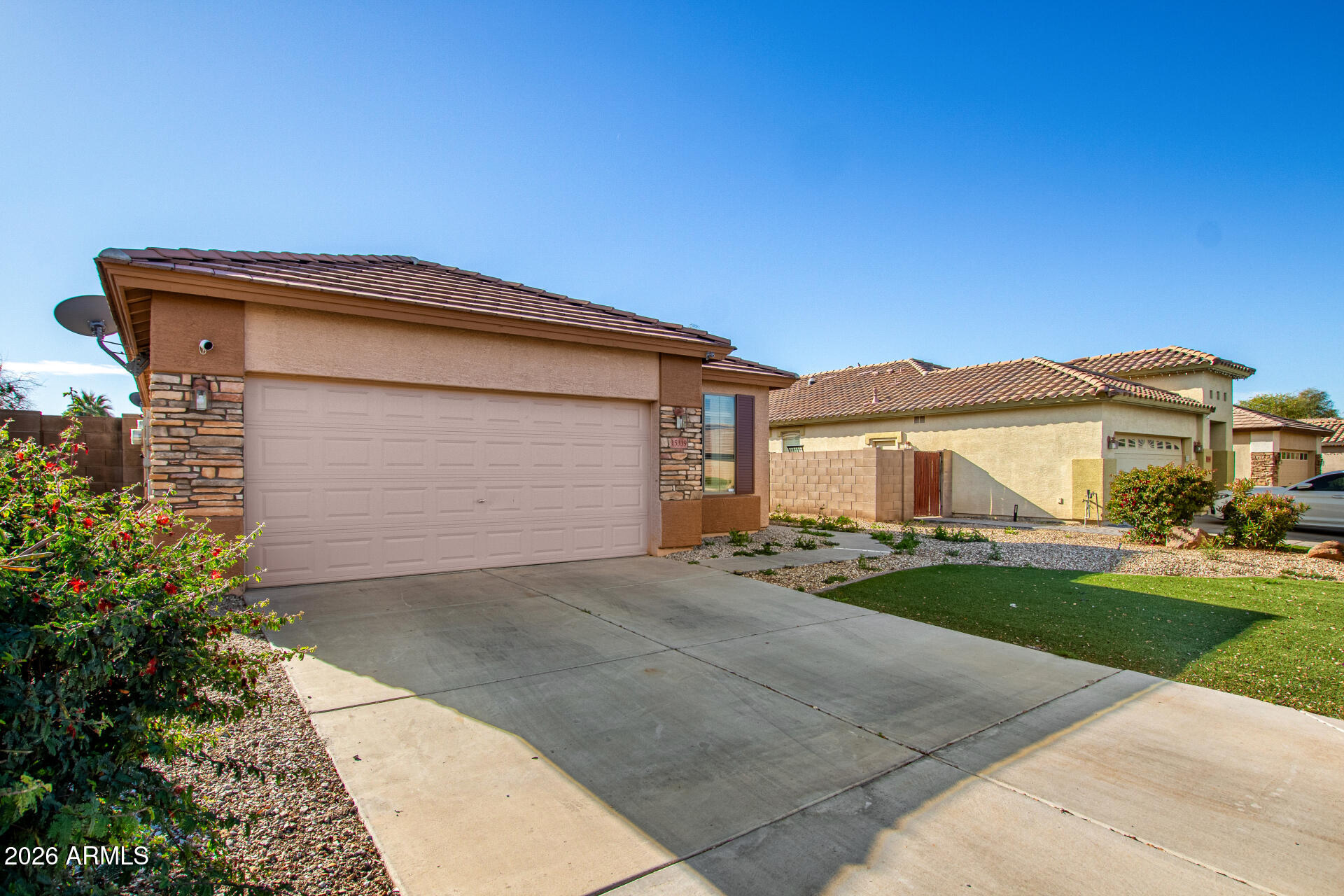 15339 West Jackson Street Goodyear, AZ 85338 - Photo 3 of 36 a front view of a house with a yard and garage