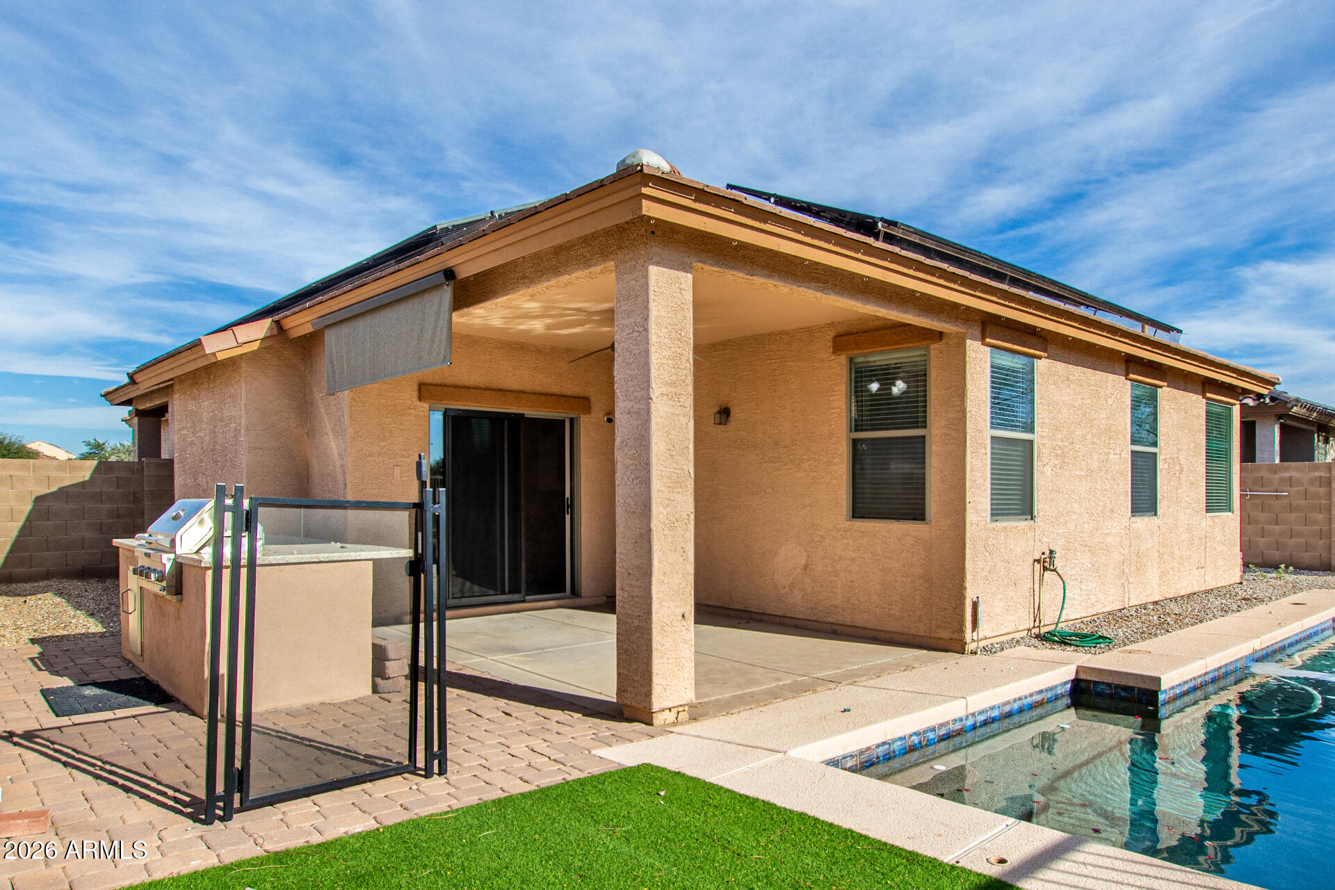 15339 West Jackson Street Goodyear, AZ 85338 - Photo 34 of 36 a backyard of a house with table and chairs