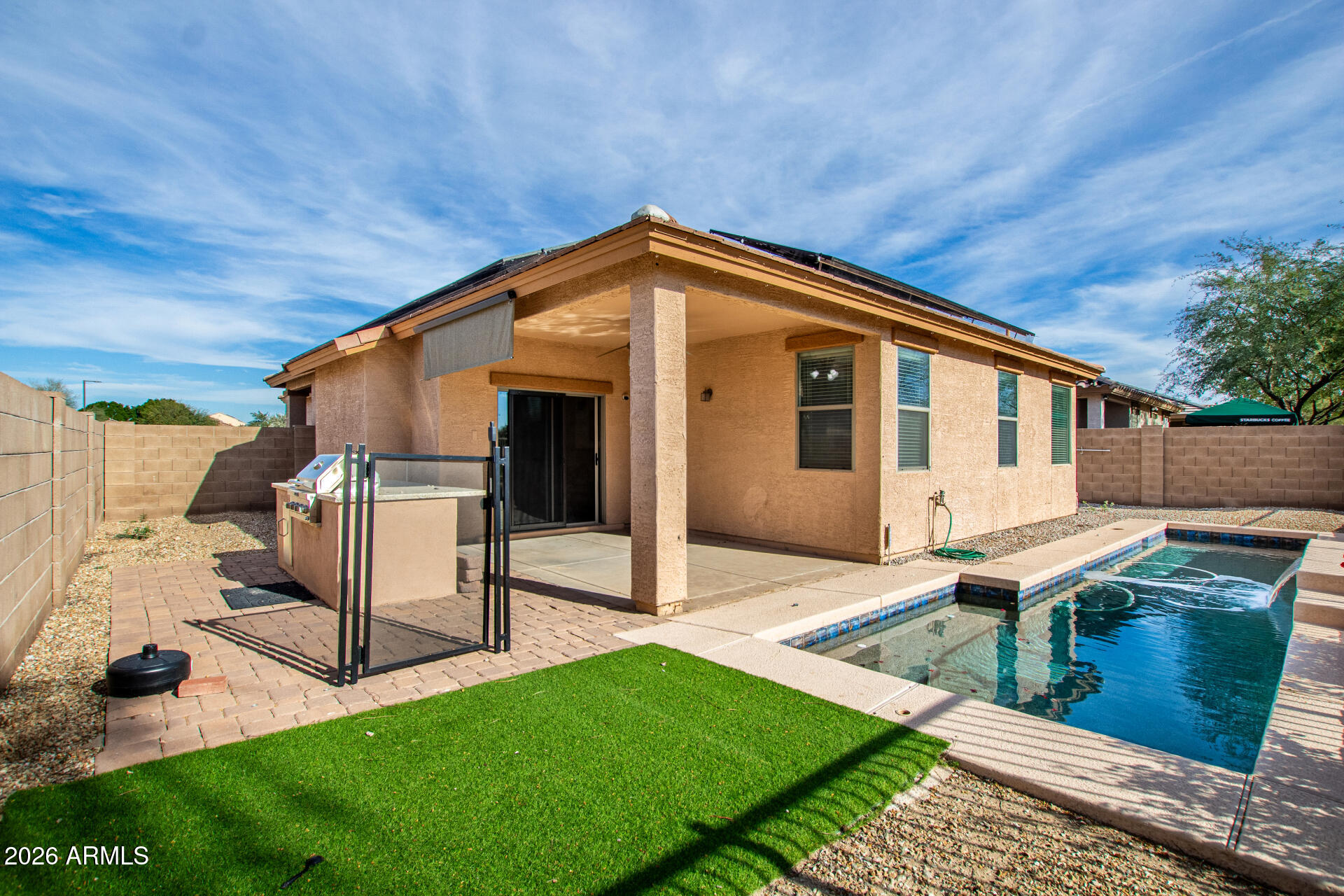 15339 West Jackson Street Goodyear, AZ 85338 - Photo 35 of 36 a backyard of a house with table and chairs