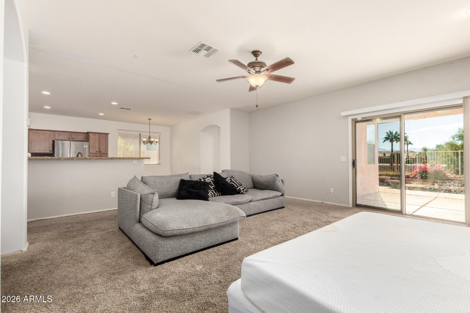 15339 West Jackson Street Goodyear, AZ 85338 - Photo 7 of 36 a living room with furniture and a large window with kitchen view