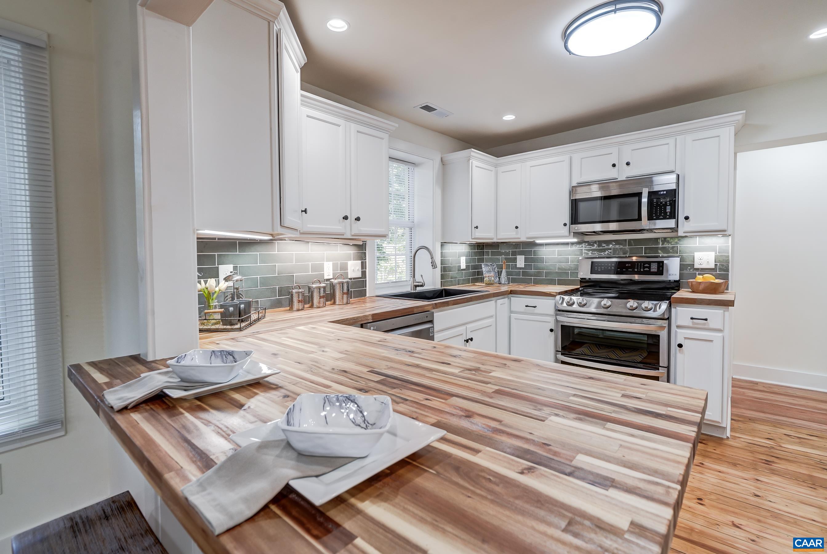 1407 Florence Road Charlottesville, VA 22902 - Photo 11 of 37 a kitchen with stainless steel appliances a stove a sink a microwave and cabinets