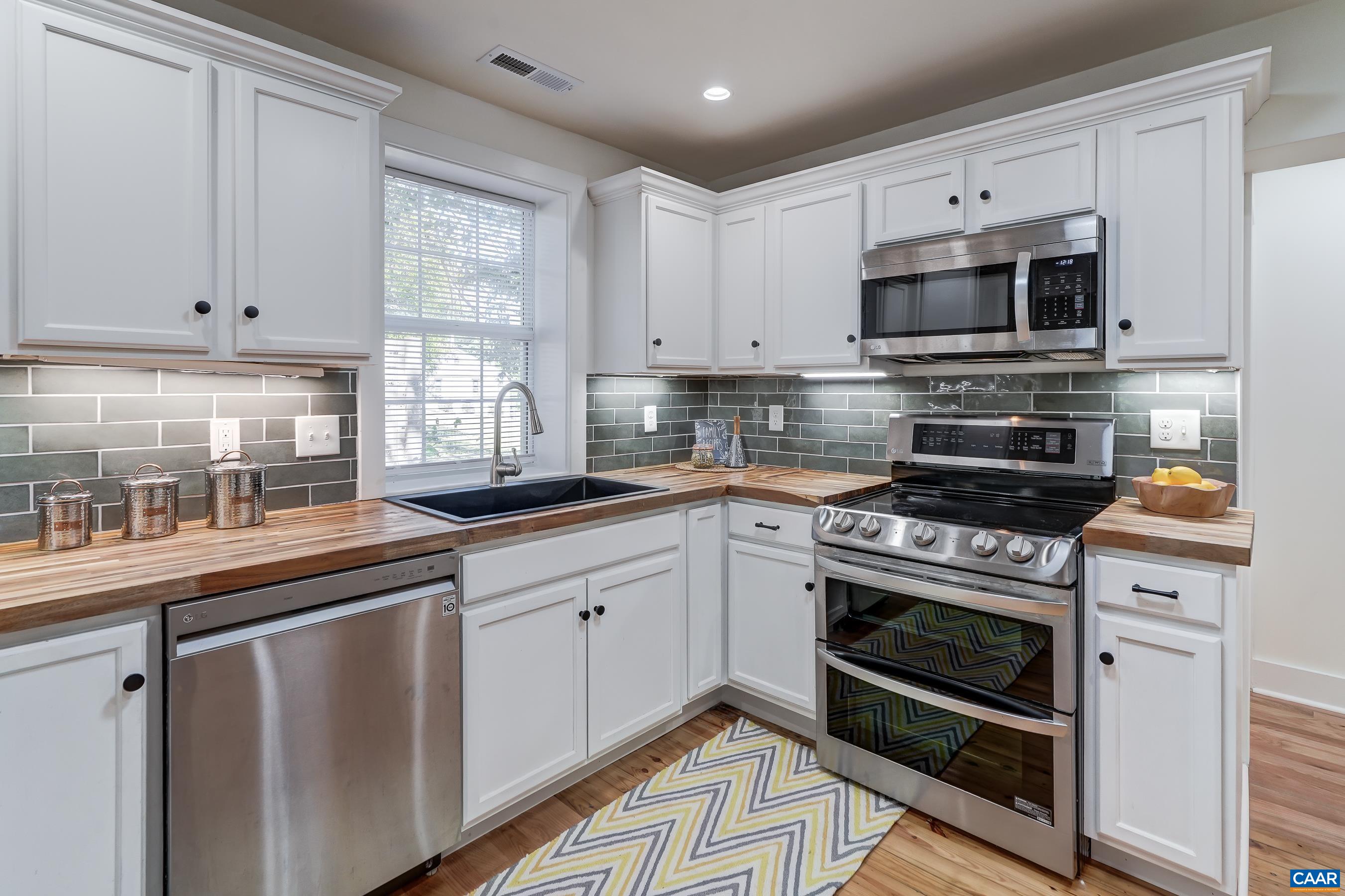 1407 Florence Road Charlottesville, VA 22902 - Photo 14 of 37 a kitchen with stainless steel appliances a stove a sink and a microwave