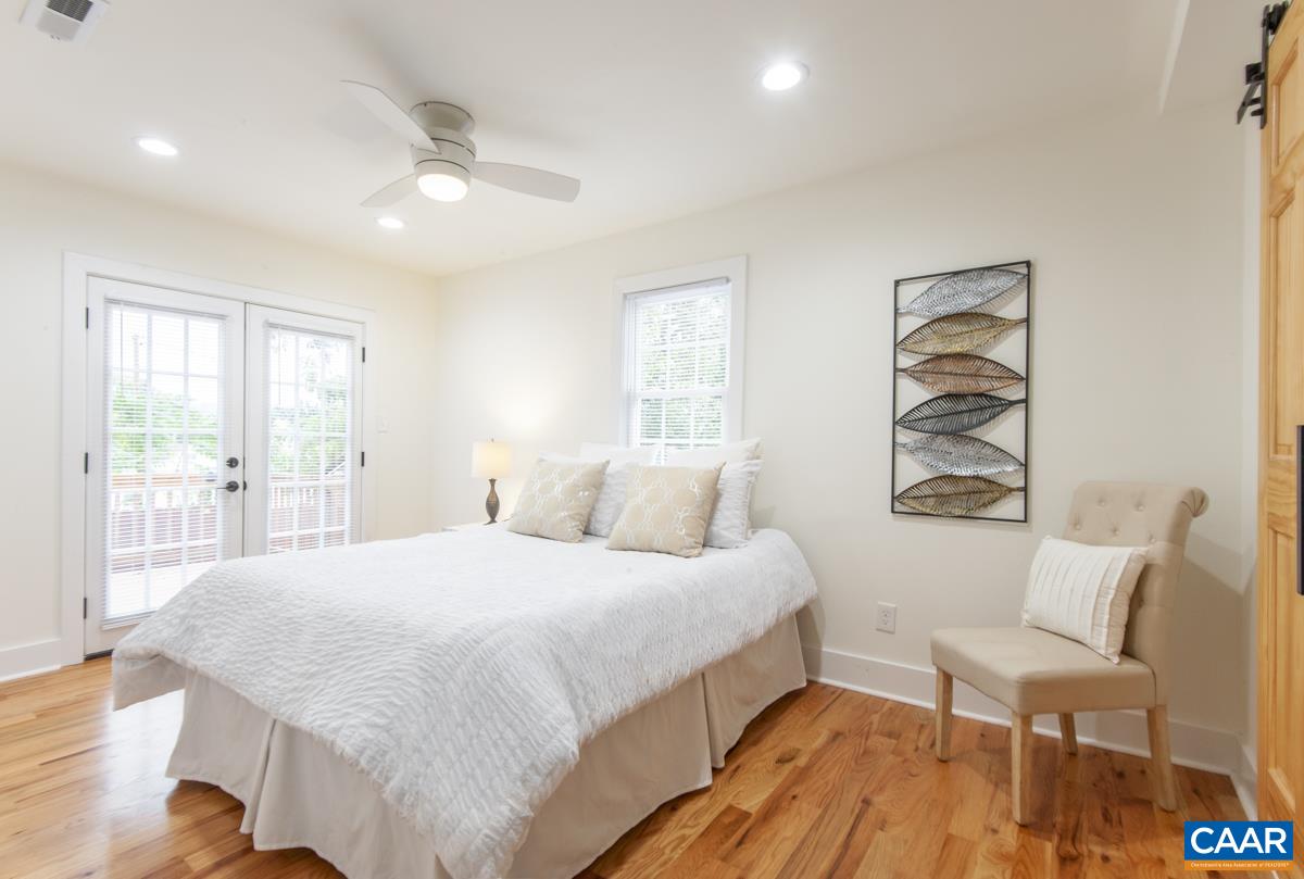 1407 Florence Road Charlottesville, VA 22902 - Photo 16 of 37 a bedroom with a bed and a painting on the wall