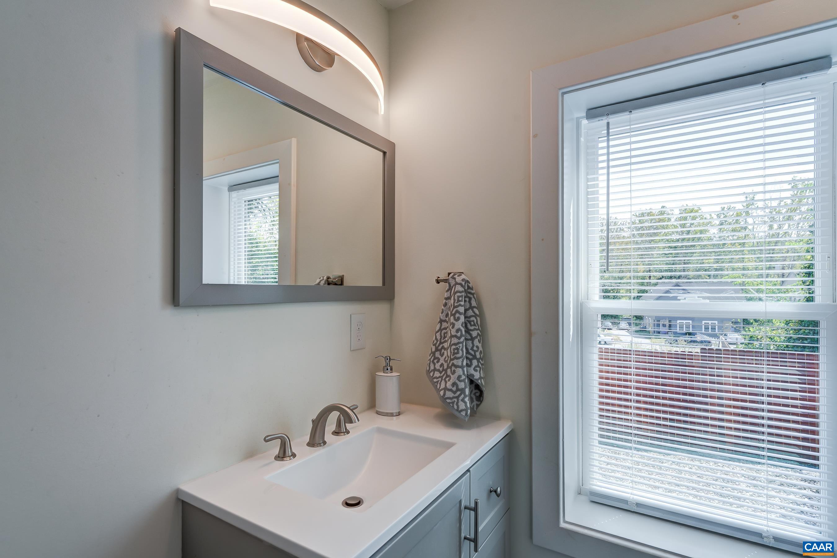 1407 Florence Road Charlottesville, VA 22902 - Photo 21 of 37 a bathroom with a sink a mirror and a window