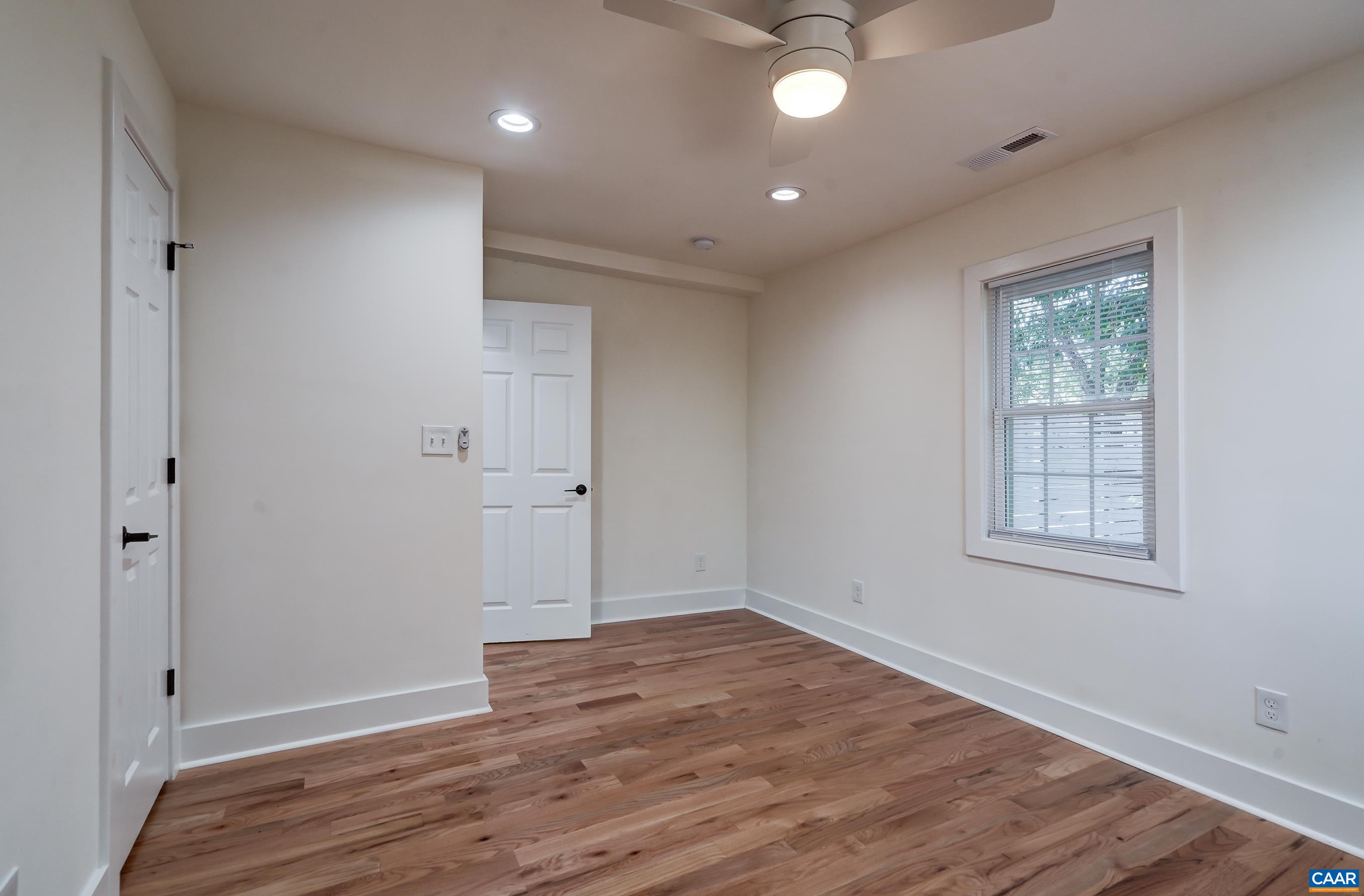 1407 Florence Road Charlottesville, VA 22902 - Photo 23 of 37 a view of an empty room with wooden floor and a window