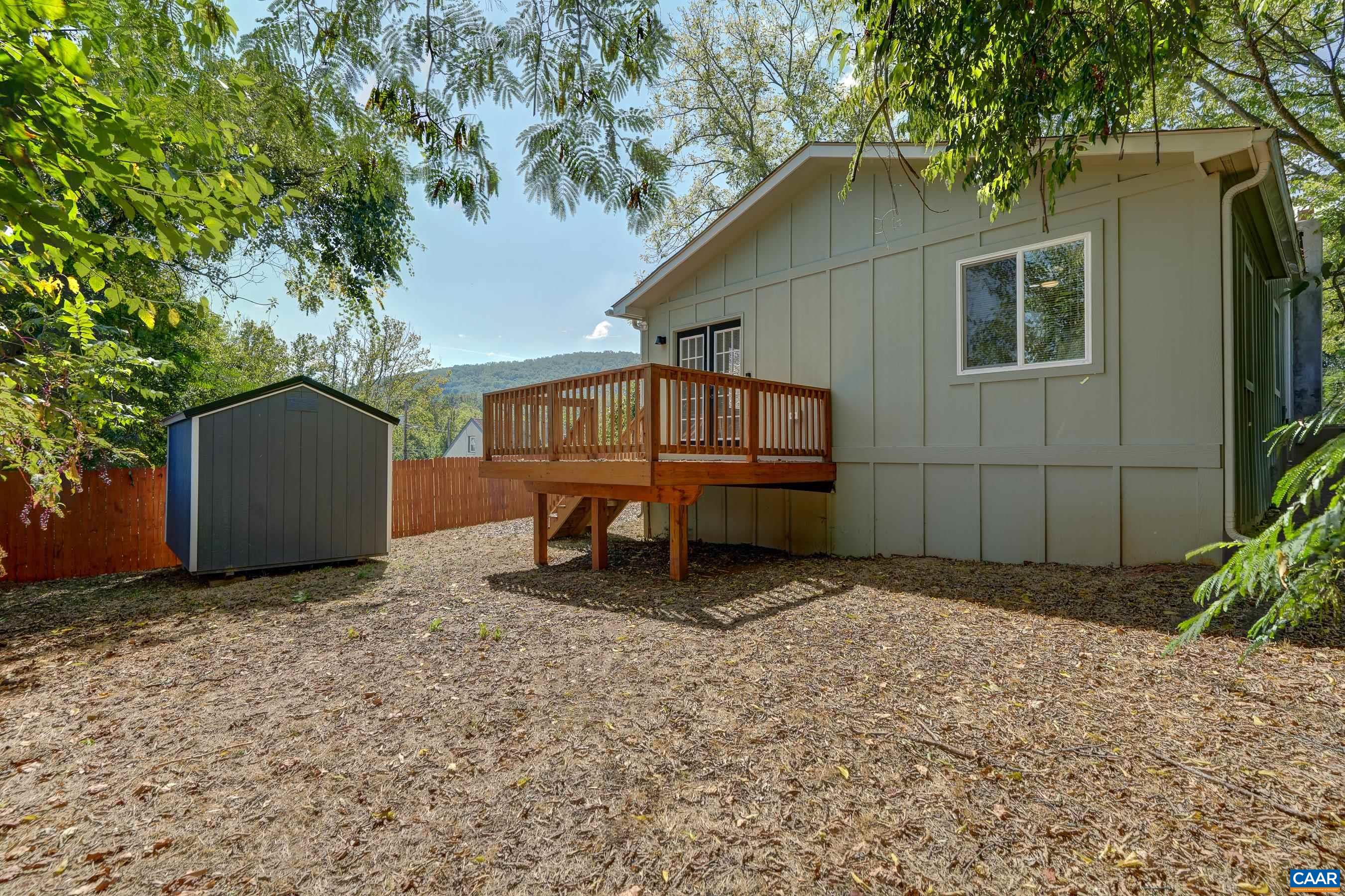 1407 Florence Road Charlottesville, VA 22902 - Photo 3 of 37 a backyard of a house with table and sofas