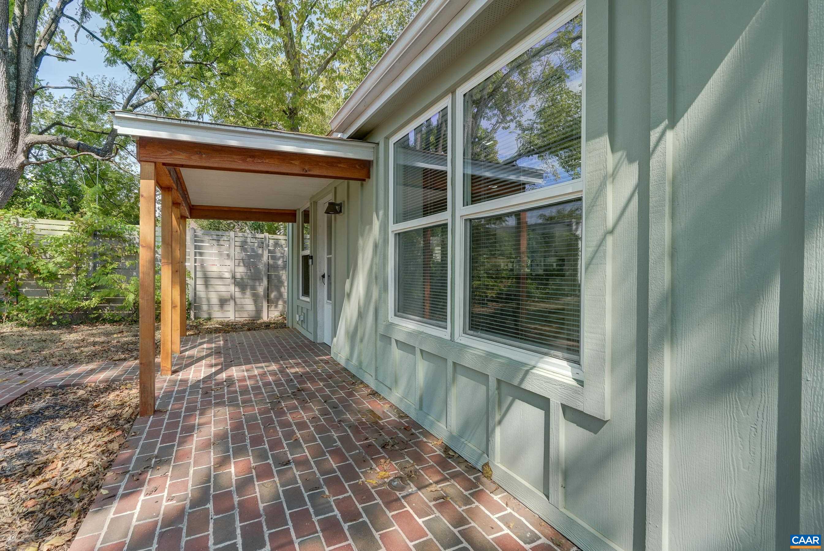 1407 Florence Road Charlottesville, VA 22902 - Photo 34 of 37 a view of a porch with a floor to ceiling window and wooden floor