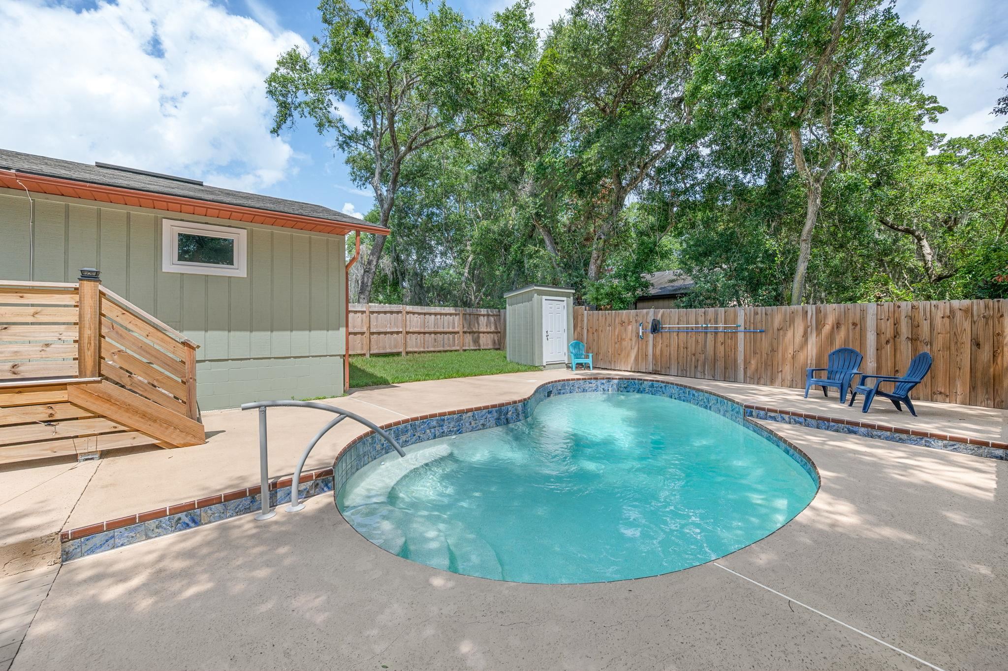 507 Gentian Road St. Augustine, FL 32086 - Photo 38 of 82 a view of a backyard with a small pool and sitting area