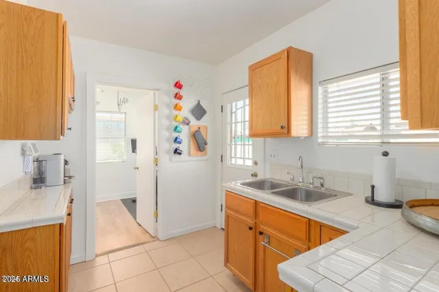 a kitchen with a sink a refrigerator and window