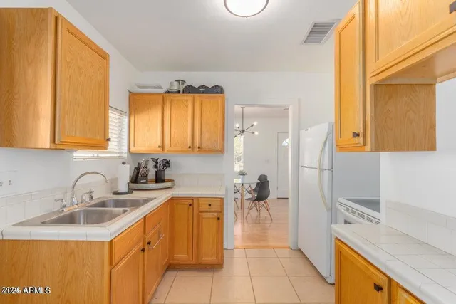 a kitchen with a sink and a refrigerator