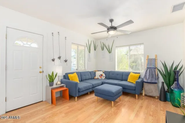 a living room with furniture and wooden floor