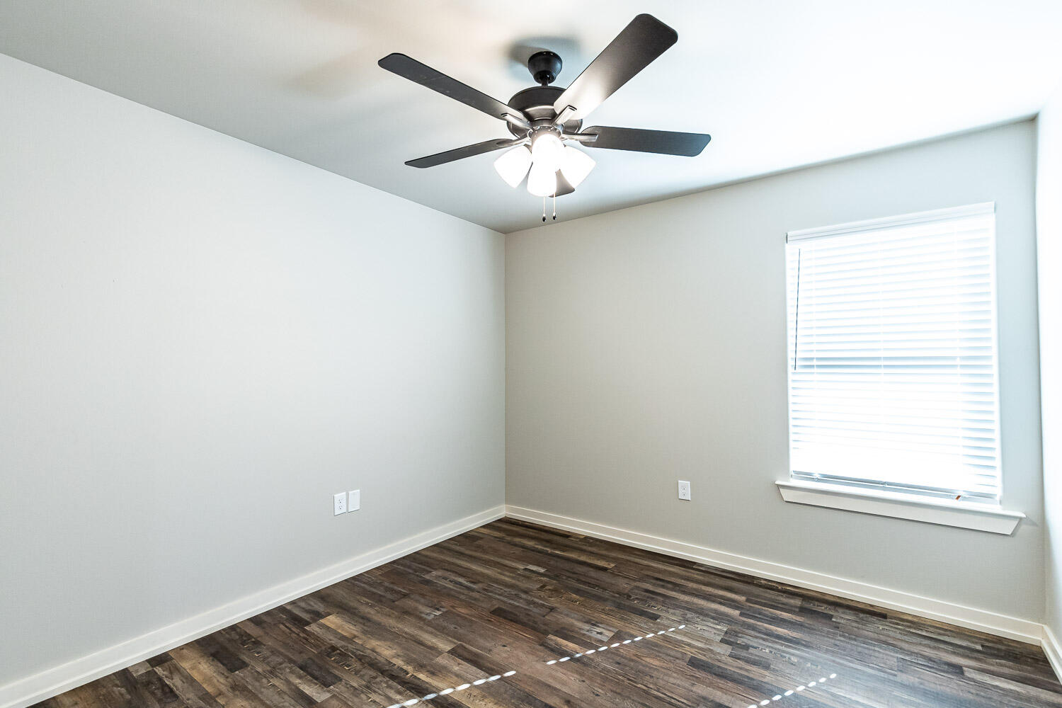 5522 122nd Street Lubbock, TX 79424 - Photo 14 of 23 an empty room with a window and a fan