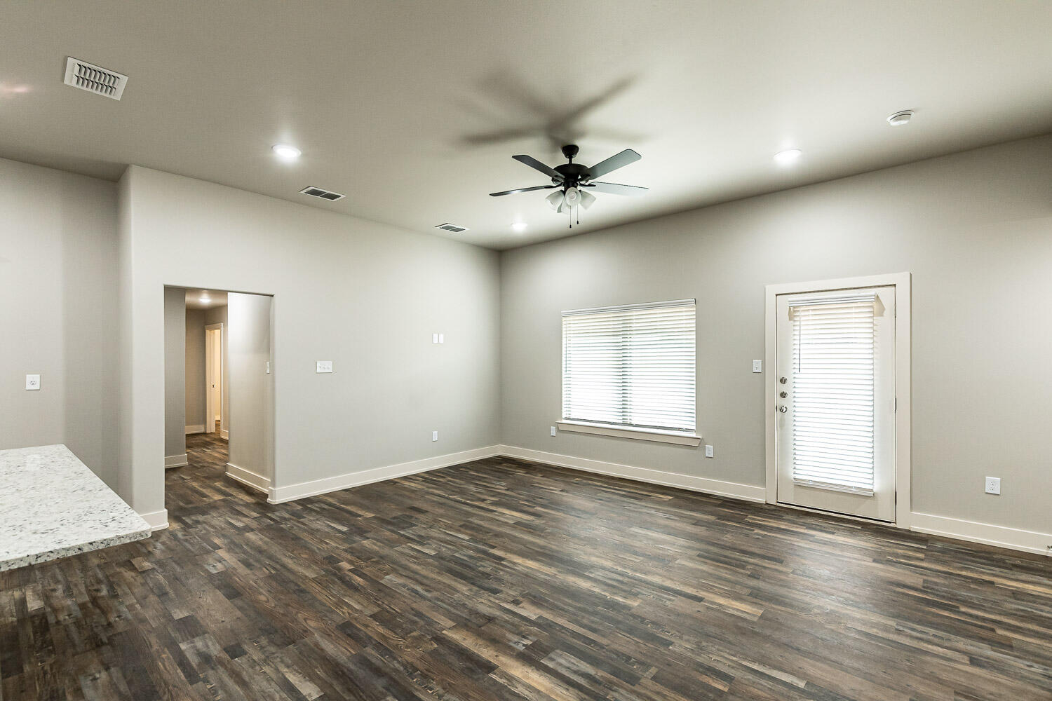 5522 122nd Street Lubbock, TX 79424 - Photo 10 of 23 a view of empty room with wooden floor and fan
