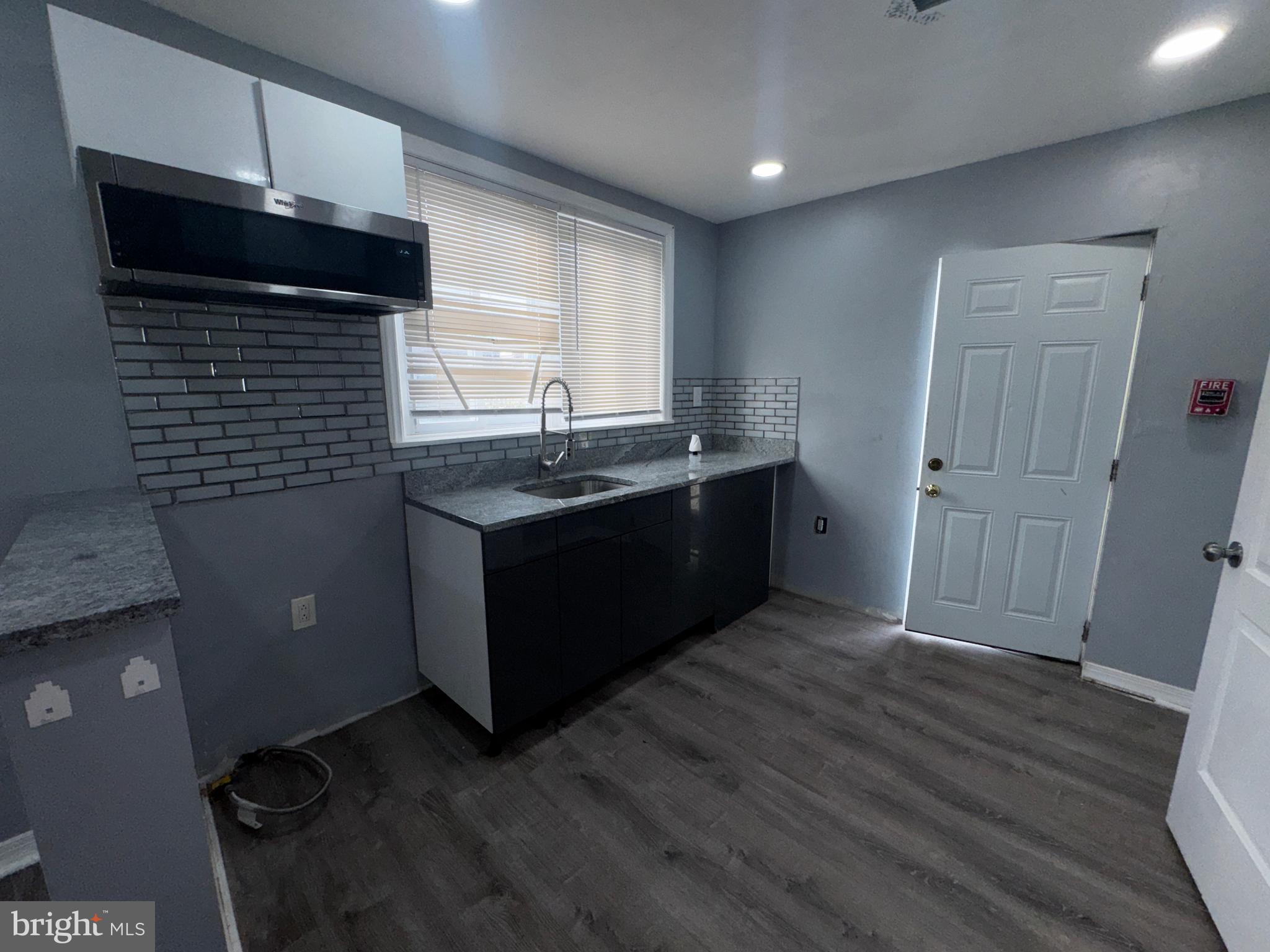 700 Lloyd Street Chester, PA 19013 - Photo 21 of 32 a kitchen with kitchen island stainless steel appliances a sink stove and cabinets
