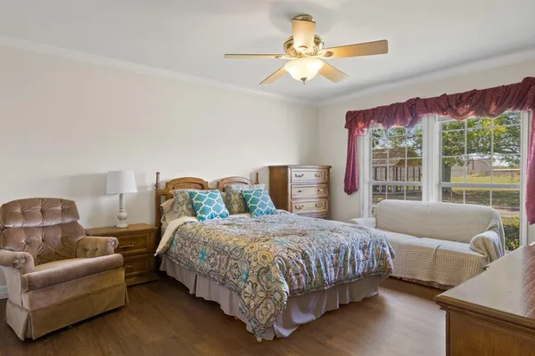 a bedroom with a bed couch and window