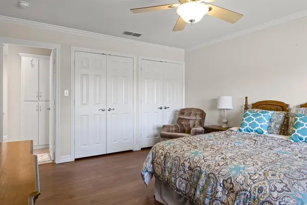 a bedroom with two beds and a chandelier