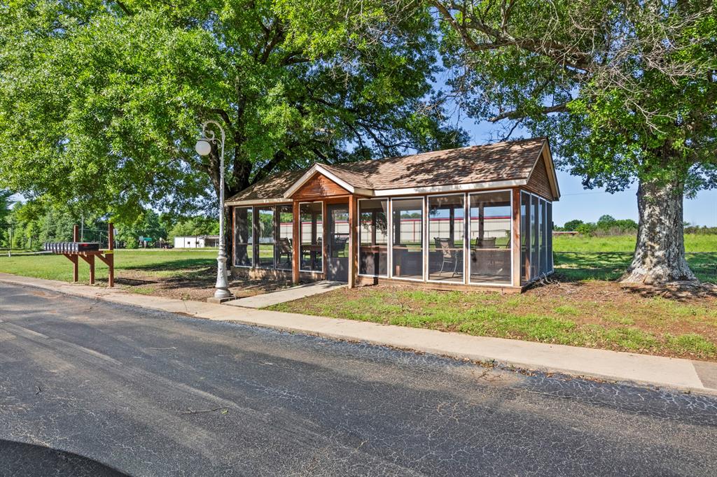 204 Pvt Road Mount Pleasant, TX 75455 - Photo 23 of 26 a front view of a house with a garden