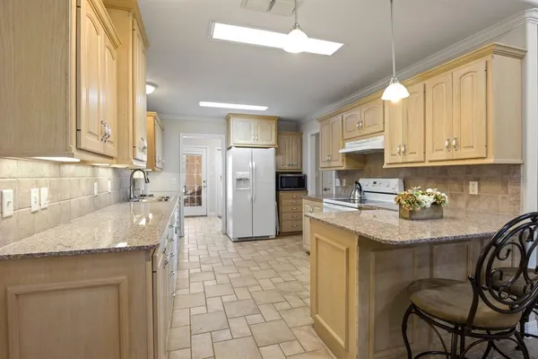 a kitchen with refrigerator and cabinets