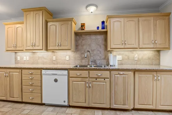 a kitchen with granite countertop cabinets and sink