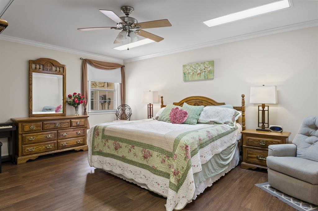 204 Pvt Road Mount Pleasant, TX 75455 - Photo 9 of 26 a bedroom with a bed and wooden floor