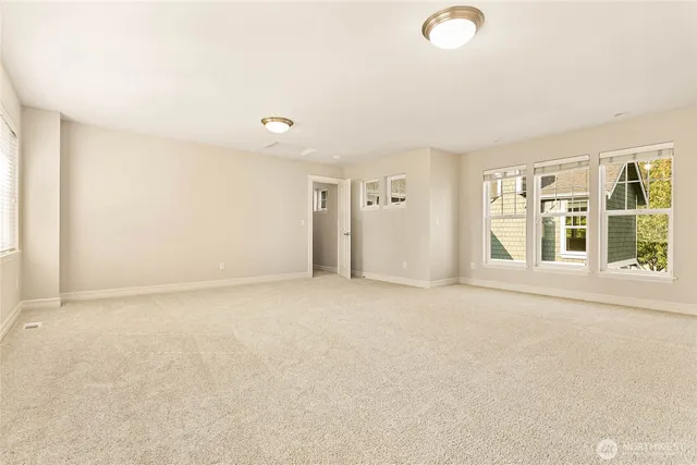 an empty room with windows and entrance